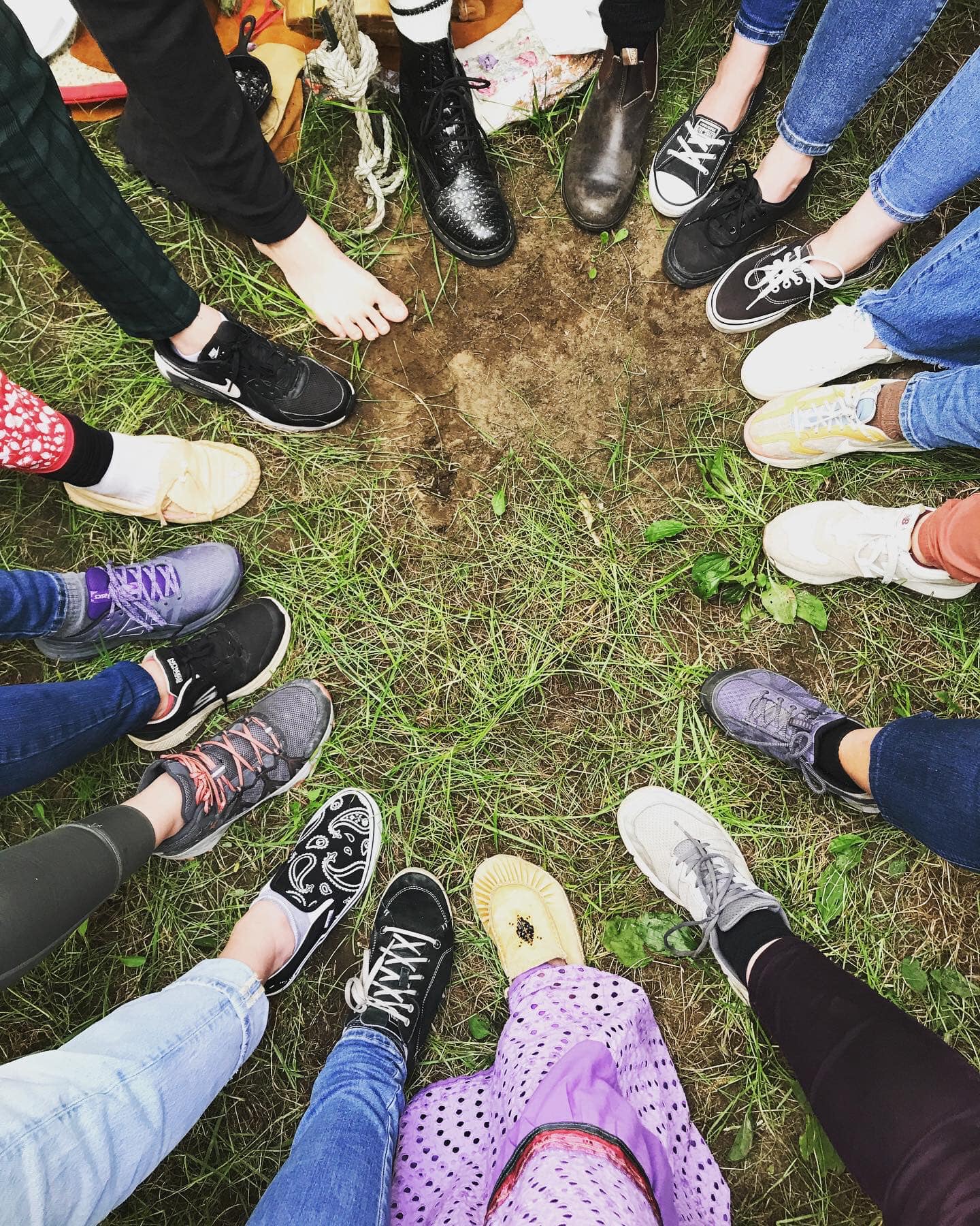 A group workshop photo taken from above, showing the participants legs and feet.